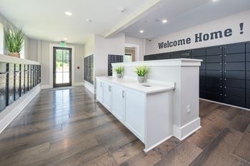 a white kitchen with a counter and a welcome home sign